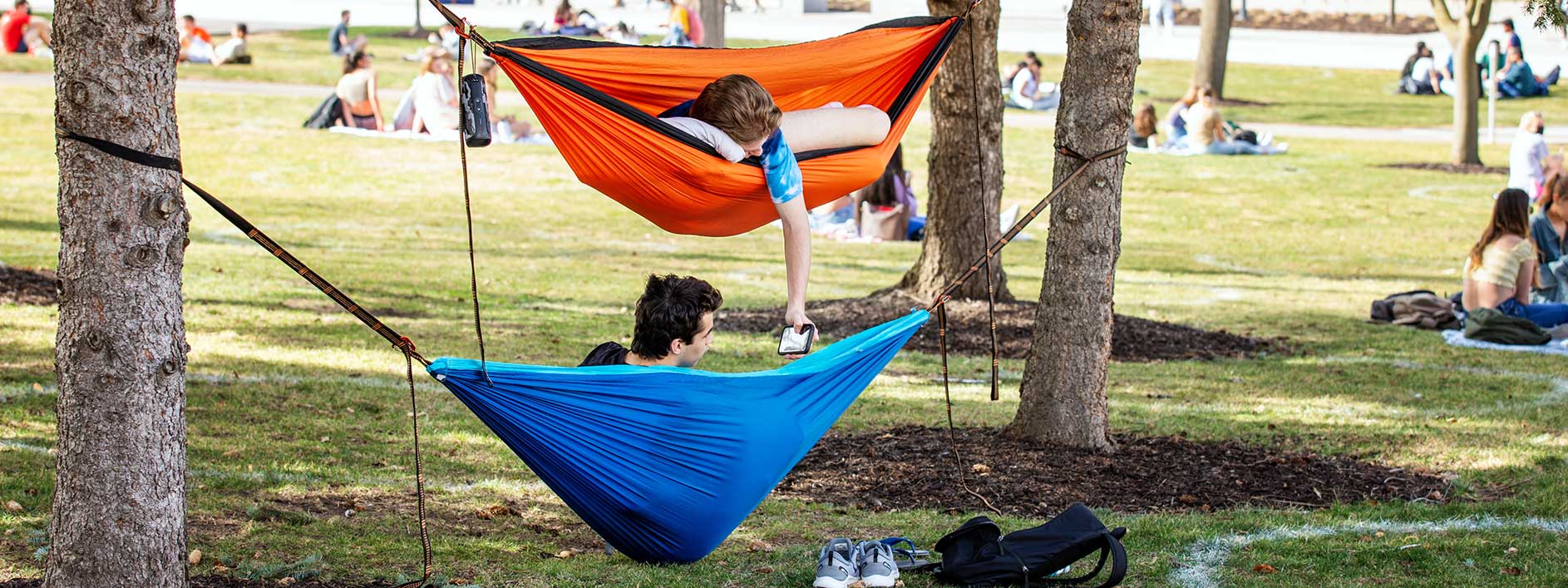 students in hammocks on campus 